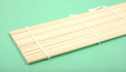 Pale Straw Bamboo Mat Close-up on Green Background