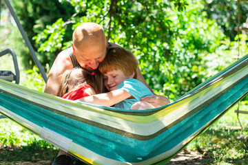 Happy children, boy and girl, hugging father, love and support in the family