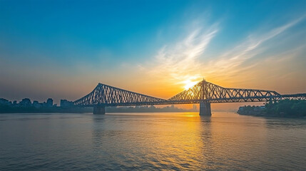 Sunset over iconic steel bridge and river
