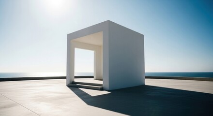 Minimalist white cube pavilion on concrete roof overlooking ocean under bright sky