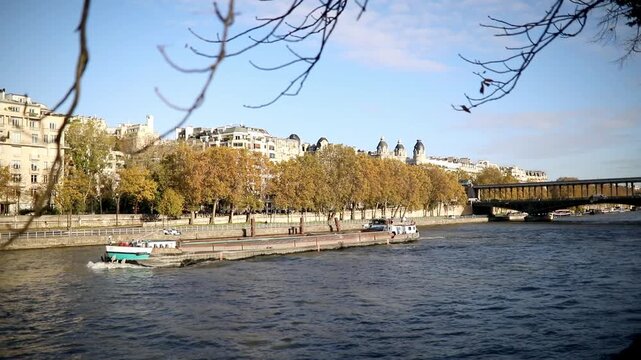 Barge floating on the river Seine on a fall day in Paris