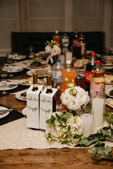 On a large banquet table during a feast there are various dishes, alcoholic and non-alcoholic drinks and dishes