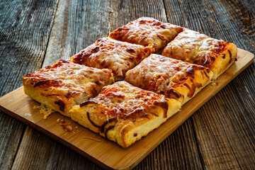 Pizza al metro margherita on wooden table