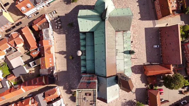 Aerial view of the iconic Ribe Cathedral with its green roof dominating the landscape amidst old buildings, on Torvet, Ribe, Denmark.