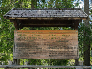 Informative Wooden Sign At Lake Carezza Entrance and Rules For Latemar Forest, Italy