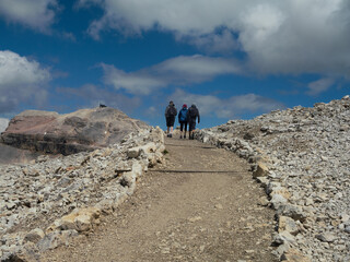 Hiking A Rocky Dolomite Mountain Trail, A Small Group Hikes Upward, Italy