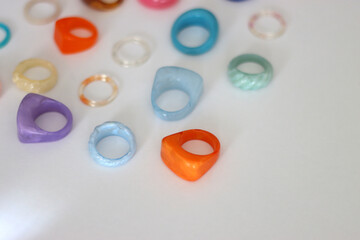 Collection of colorful plastic rings on white background. Selective focus.