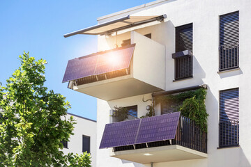 Solar Panels on Modern Balcony Apartment Building with Balcony Canopy and Sunlight Reflection. © Maryana