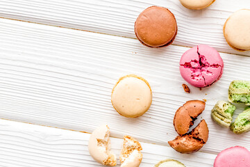 Macarons dessert pattern on white wooden background top view copy space