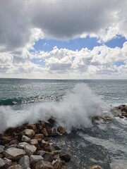 Waves Crashing on Rocky Shore under Dramatic Sky
