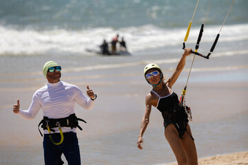 Kitesurfing Training on the Beach with Instructor and Woman