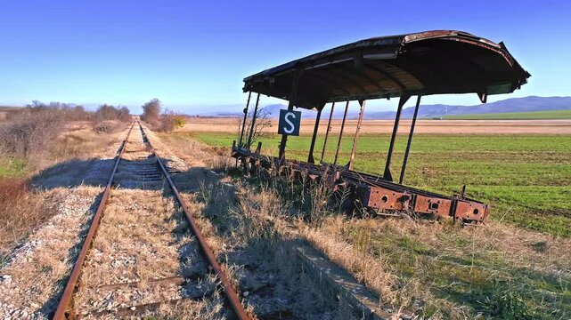 Rail station in the fields, rusted broken wagon, sunny autumn day