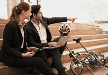 Commuting to work with bicycle. Businessman businesswoman cycling to office in downtown district....