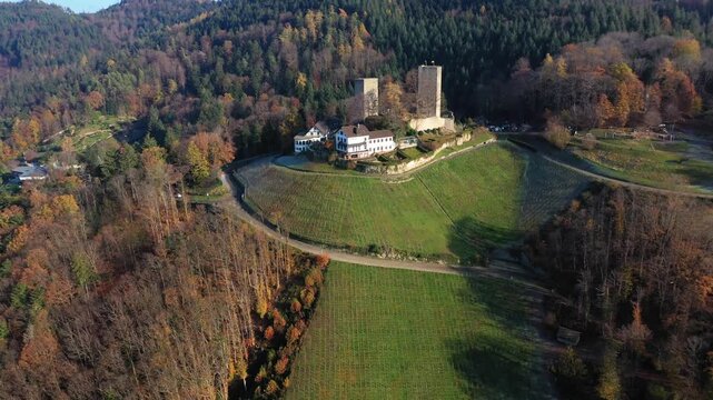 Aerial view of Windeck Castle surrounded by autumn-colored trees and green fields, a beautiful contrast of nature and architecture, B&uuml;hl, Baden-W&uuml;rttemberg, Germany.