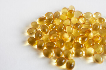Fish oil capsules on a white background. Close up. Selective focus.