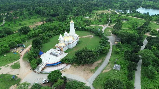 Aerial view of the Surya Mandir temple, a white structure with golden domes, surrounded by lush greenery, a serene landscape, Bundu, Jharkhand, India.