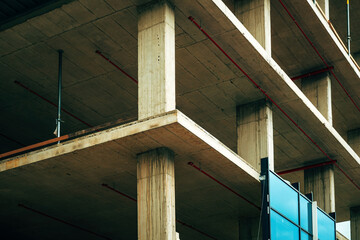 Low angle view of modern corporate office building construction site, concrete frame structure with...