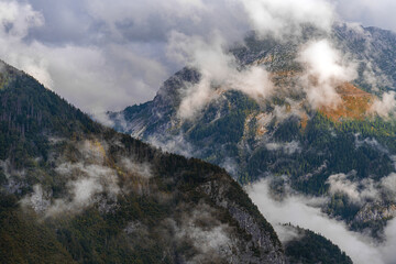 Julian Alps mountains in fog and clouds, dramatic alpine landscape in Slovenia.