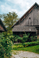 Rustic wooden worn farm shed in Slovenian Alps countryside.