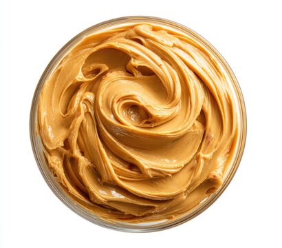 Creamy peanut butter in a clear glass bowl, swirls of smooth texture
