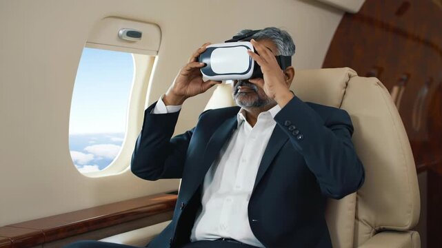 Man using VR headset on private jet, looking out window at sky; virtual reality, travel, technology, airplane, business, innovation concept.