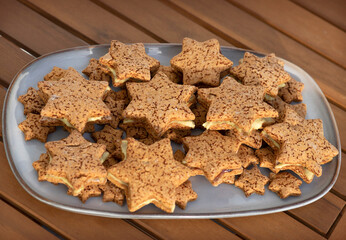 Homemade Gluten-Free Star Cookies on Long Platter with Pistachio Cream and Fruit Jam Filling