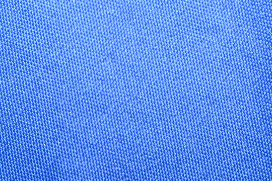 A detailed macro photograph capturing the fine, tight weave and uniform textured surface of a brightly colored textile, ideal for a simple and striking background.