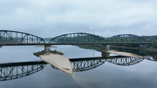Aerial Fordon Poland Bridge Vistula River traffic pull. Royal town Kingdom of Poland. Constructed in 1950's after WW II destruction. Steel arch structure. Transportation vehicles, walking, railroad. 