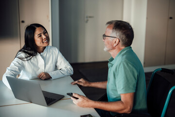 Doctor consulting patient in wheelchair during clinic appointment