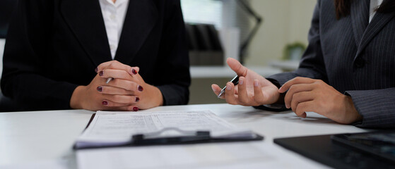 Close up. two business people talking, planning analyze investment and marketing in office. Business meeting to brainstorm the new project and analysis data document.