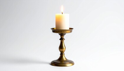 Lit white candle in a classic brass candlestick holder with round base and slender stem, placed on a plain white background, evoking warmth, tradition, and minimalist elegance.