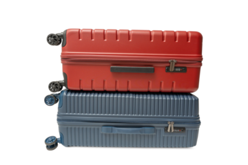 Red suitcase stacked on top of a blue suitcase on a transparent background in PNG format. Both are hard-shell travel luggage with wheels.