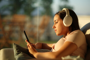 Serious woman is listening audio checking mobile phone