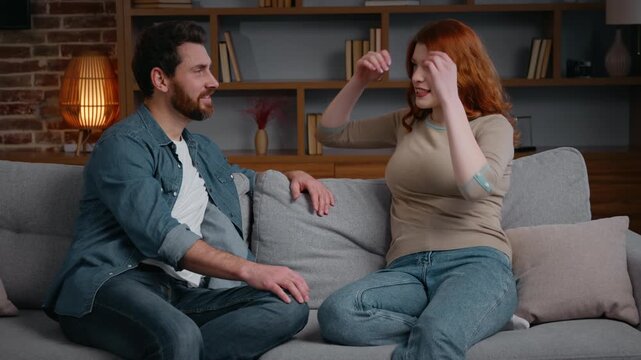 Caucasian family couple in evening home carefree talking spending time together smiling relatives friends married husband wife speak cheerful conversation girlfriend woman boyfriend man discuss plans