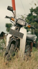 Front View of Retro Vintage Japanese Cub Motorcycle in Countryside View with Classic Warm Tone Photo