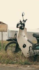 Side View of Retro Vintage Japanese Cub Motorcycle in Countryside View with Classic Warm Tone Photo