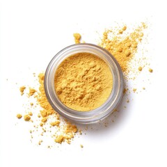 A small, clear jar holds a vibrant yellow powder, some of which spills onto a white background in a scattered pattern
