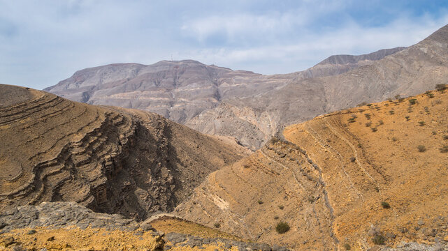 Arid rocky landscape of Hajar mountains with view to Djebel Jais Ras Al Khaimah