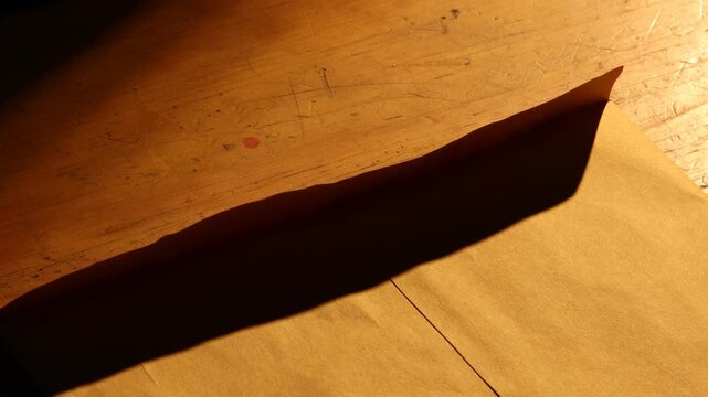 Close-up of someone opening the document marked as DRAFT, likely a preliminary analysis report. nested within an envelope