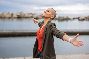 Mature woman with shaved hair in the city on a rainy day. Barcelona/??Spain