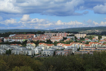 Naklejka premium Panoramic Landscape of Brno, Czech Republic City View with Fields, Mountains, and Fluffy Clouds