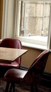 Slow Pan Across Vintage Leather Chairs in English Cafe