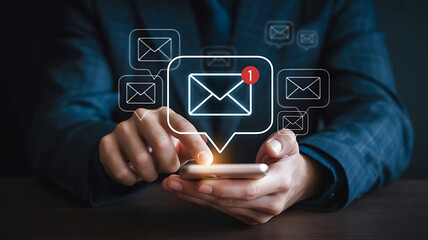 Person holding smartphone with glowing email notification icons appearing above the screen symbolizing digital communication