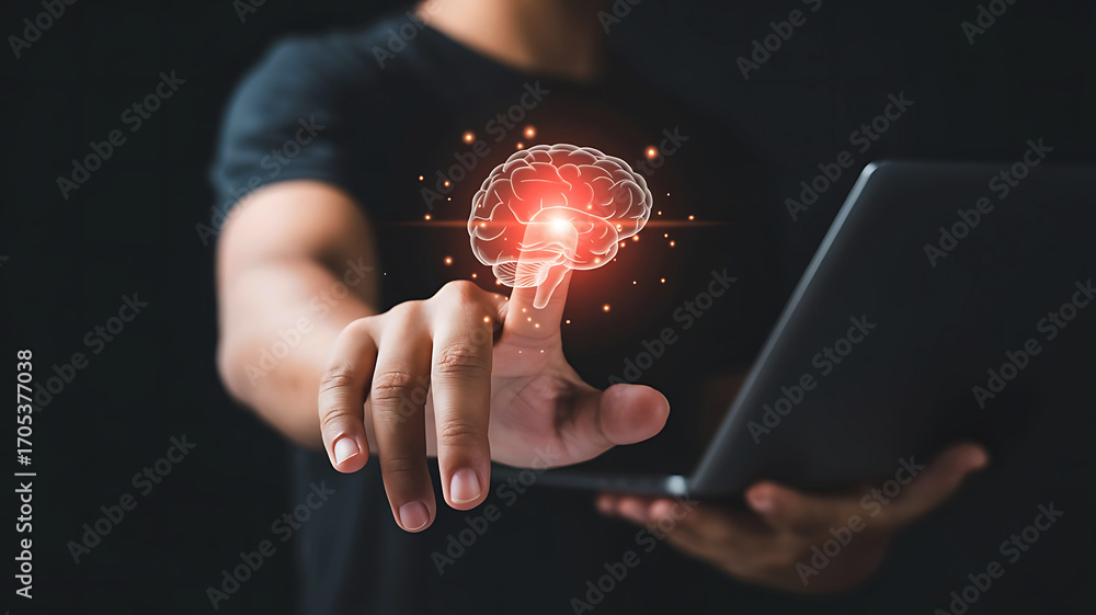 Poster close up of a person s hand touching a glowing digital brain hologram with a laptop in the backgroun