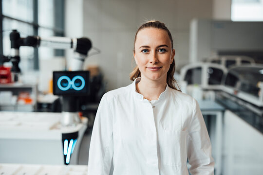 Scientist in lab coat smiling in modern research laboratory - Powered by Adobe