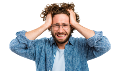 Man with curly hair, distressed expression, holding head