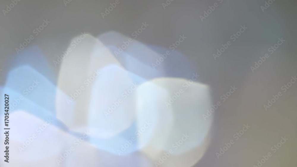 Poster abstract light background with blurred blue, white and tan colors creating a bokeh effect.