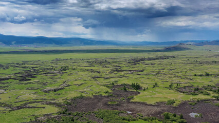 Obraz premium Steppe and mountains with rain landscape