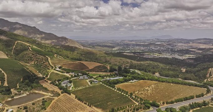 Stellenbosch South Africa Aerial v2 flyover Delaire Graff Wine Estate capturing lush hillside vineyards, views of mountain landscape and townscape - Shot with Mavic 3 Pro Cine - Jan 6th 2024