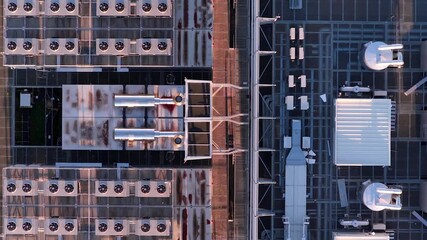 Top down aerial shot of data center rooftop in Warsaw, Poland, showing cooling fans, ventilation systems, and technical infrastructure of secure digital facility. - Powered by Adobe